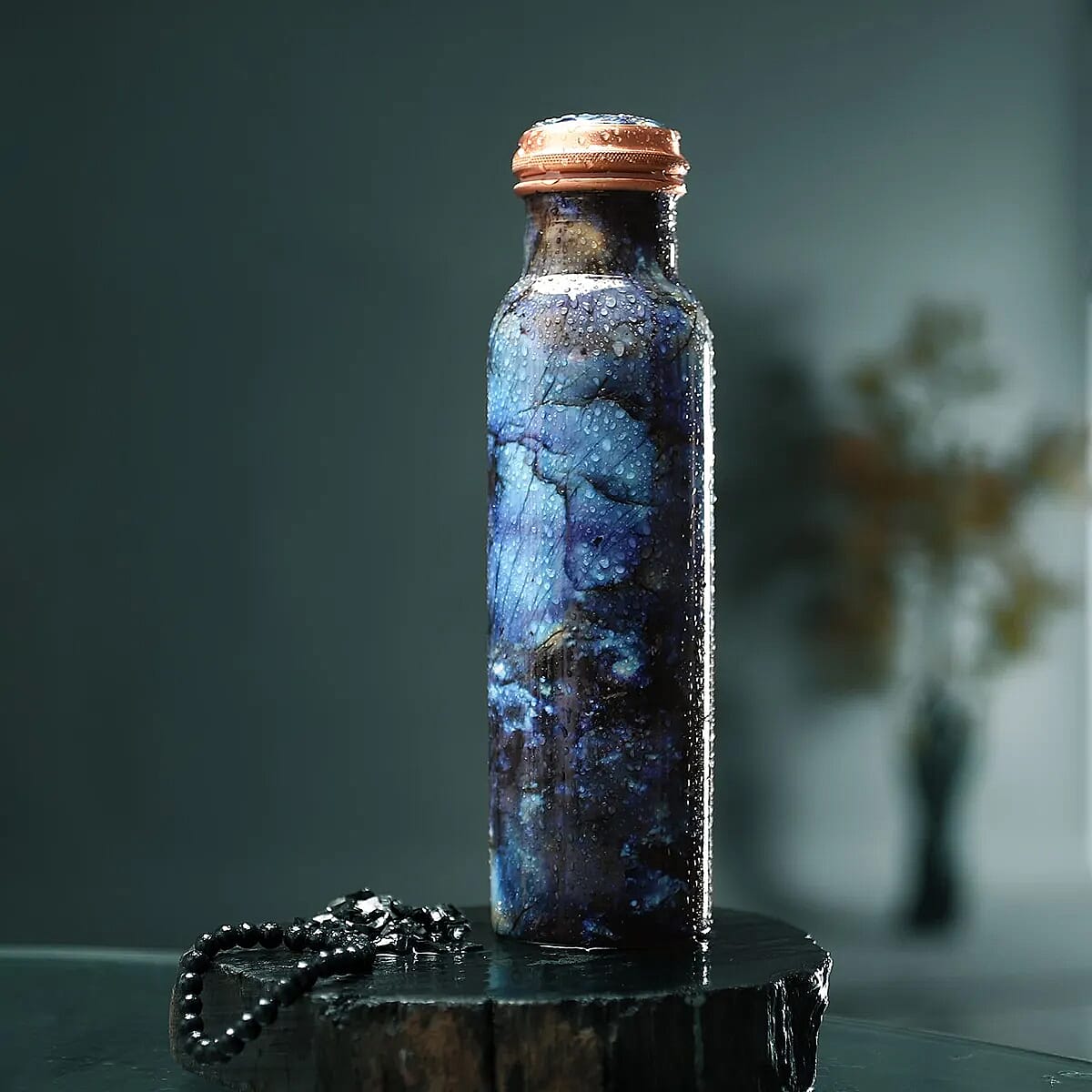 Multi Color Printed Copper Bottle with Shungite Infuser and Shungite Bracelet  Bottle Size: Height- 10.6 inches, Diameter- 2.75 inches, Bracelet - 6mm Bottle Capacity: Approx. 32 Oz.